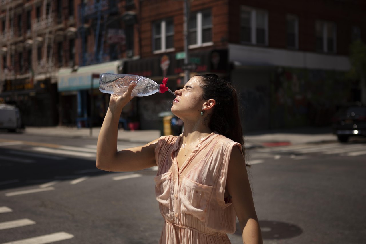 young-woman-tolerating-heat-wave-with-cool-drink